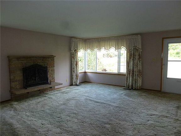 Living room features raised hearth stone gas fireplace.  Fantast