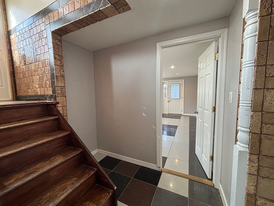 Access to split level suite using the main entrance. View of the black and white tiled bedroom.