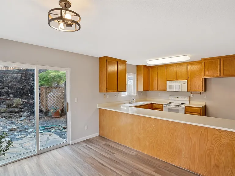 The view of the kitchen from the dining room.