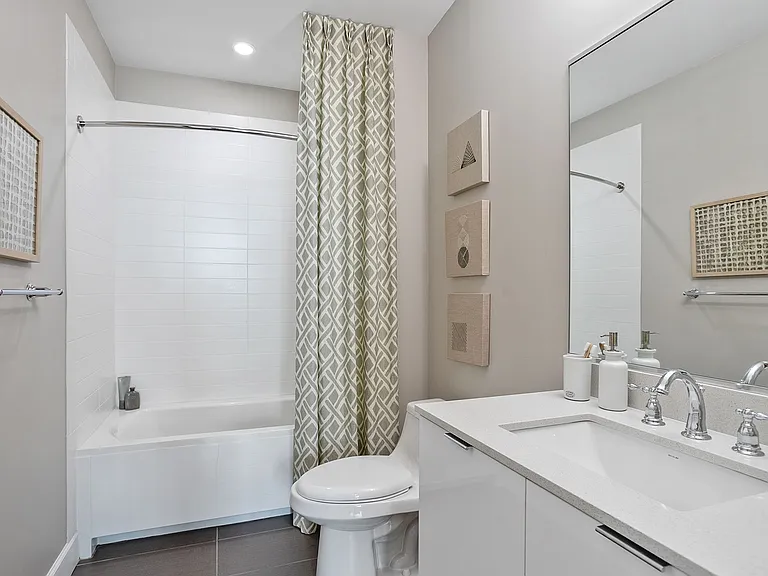 A bright, modern bathroom designed with stylish fixtures and a spacious vanityoffering a calm, comfortable setting for everyday routines