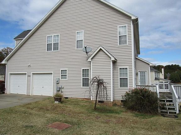 Side of house with two car garage. Garage has separate work