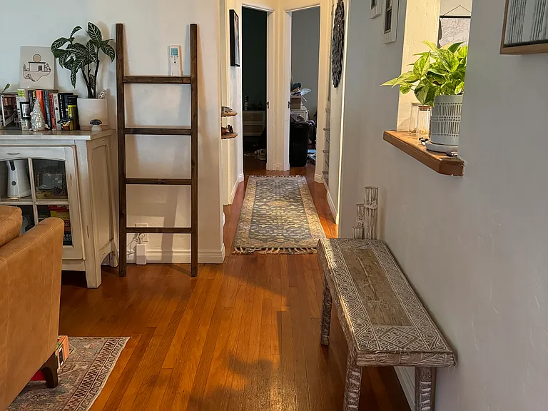 view from living room down hallway to two bedrooms in back of home