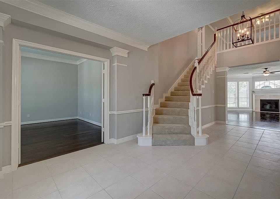 WELCOME TO 12410 Lakeshore Ridge. As you enter, this is the stunning view you see. Office has newly installed hardwood flooring, two story foyer with designer chandelier and flows into the family room with gas log fireplace, open floor plan and great