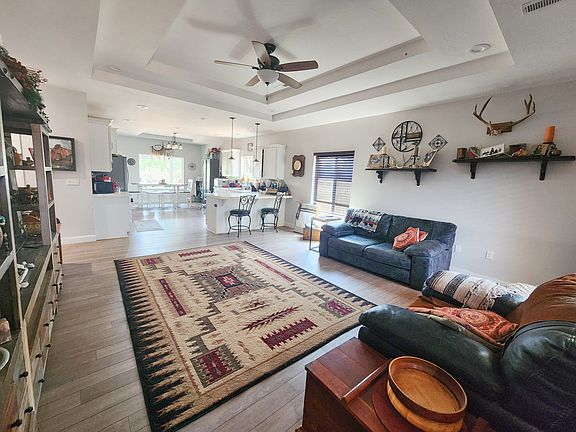Open concept floor plan with recessed lighting and tray ceiling and tons of natural light