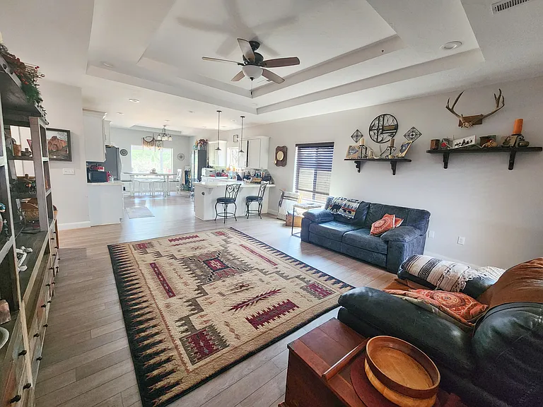 Open concept floor plan with recessed lighting and tray ceiling and tons of natural light
