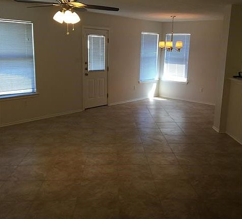 Open kitchen, living, dining area with new tile floors, new