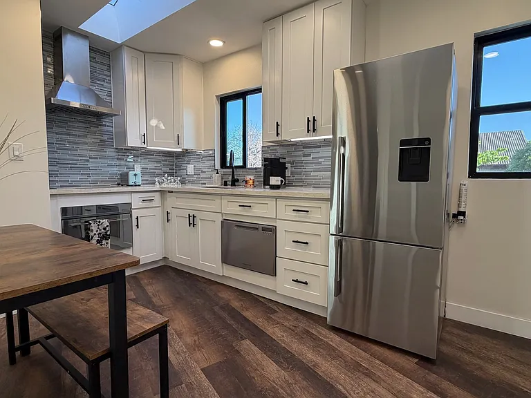 Full Kitchen with Miele appliances with refrigerator, dishwasher, electric cook top, and combination microwave/convention oven