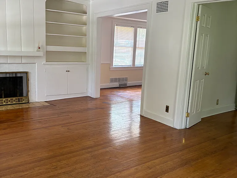 View from front door into living room. 1st Bedroom doors on the right and dining room on the left.