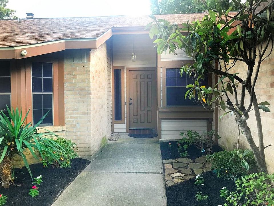 Front porch features a large kitchen window overlooking over looking a pretty dry creek bed.
