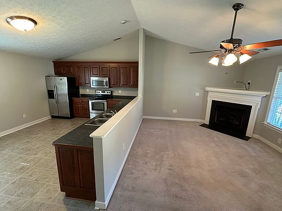 Kitchen open into living room with vaulted ceilings