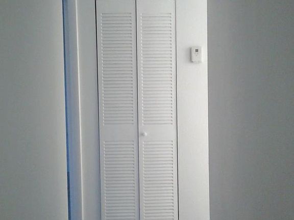 Hallway leading to rooms and bathrooms