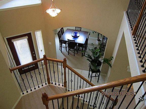 View of nice entry way with  the rod Iron stair way.