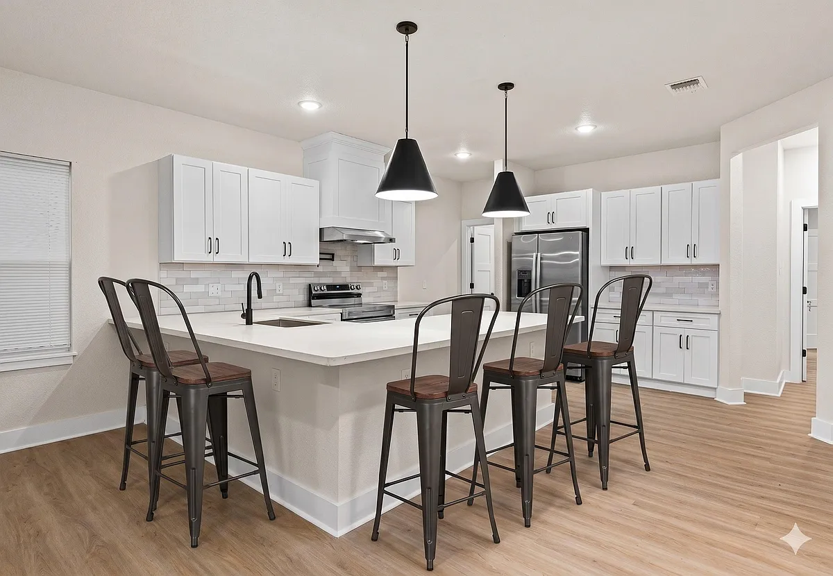 Open kitchen with a large island and seating, ample cabinet storage, and stainless-steel appliances for everyday cooking. - Carle Ave