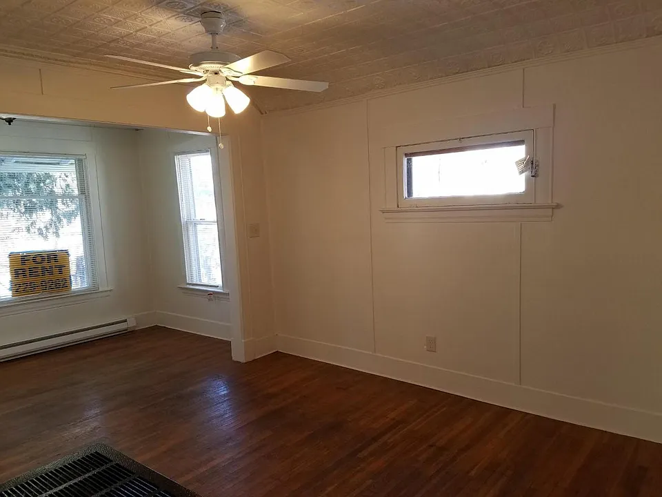 High ceilings, see the 1900's embossed tin above the fan, with original hardwood floors.