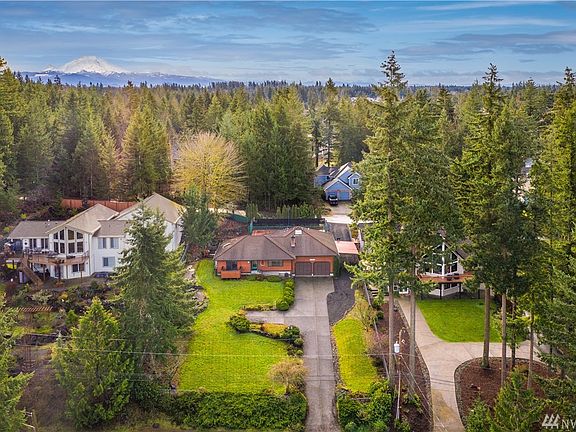 Serene lake view setting with expansive front yard.