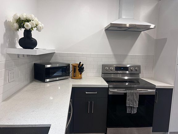 New appliances well lit kitchen area.