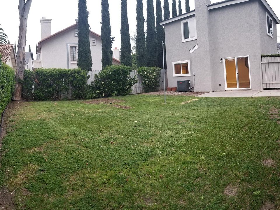 Your private backyard! (We pay for the gardener) The downstairs window above the A/C is the kitchen so you have a beautiful view. The living room is inside of the sliding glass doors and the two upstairs windows are bedrooms #2 and #3.