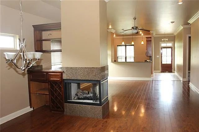 View from dining area with open floor plan to large living area with glass fireplace