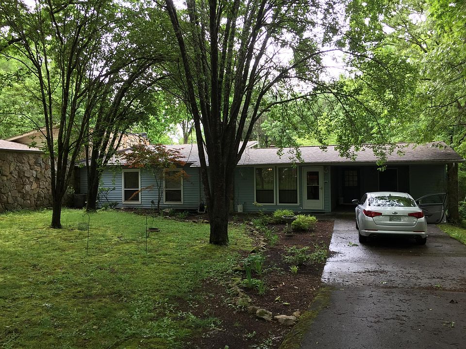 Private flat driveway with carport and additional storage .
