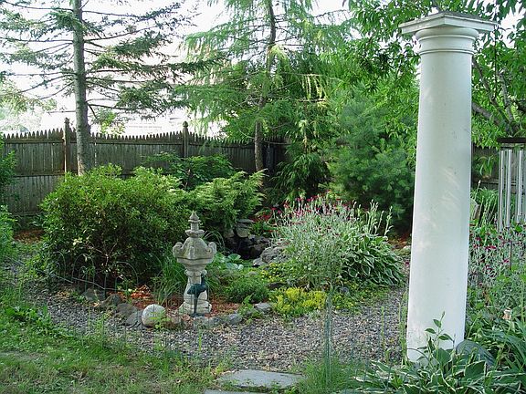 Fenced yard w/ man made pond