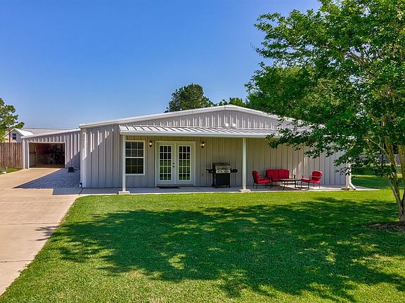 Front view with 10 ft wide garage door opening to the hangar. This home is well maintained and the attention to detail is everywhere.