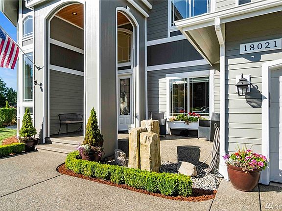 Beautiful covered entry welcomes you with tranquil water feature and space to sit and relax