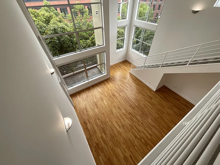 Stunning windows provide ambient light and dressed with roller shades.