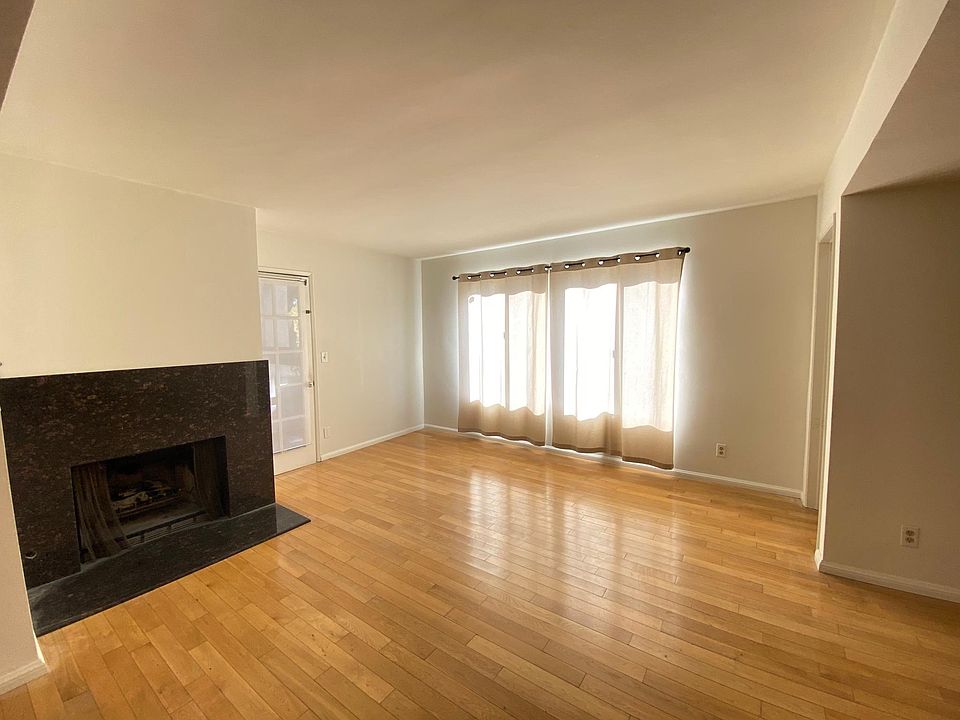 Bright living room with fireplace and balcony