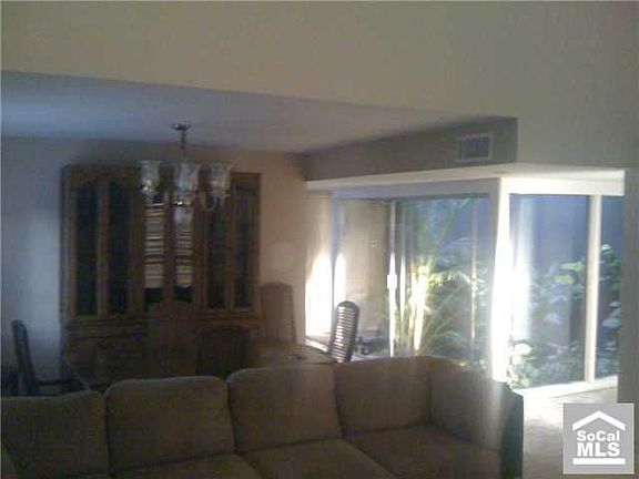 Front Living Room and Formal Dining Room with Atrium in the Center