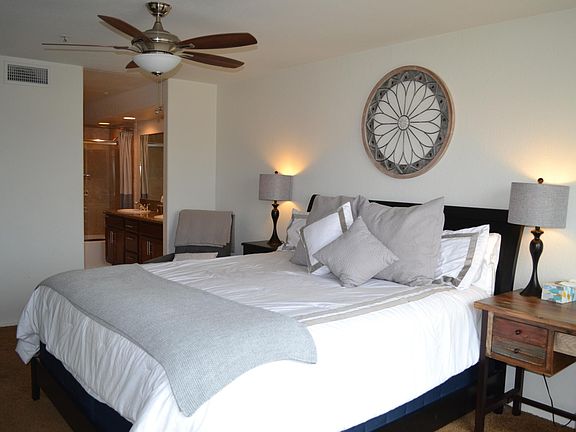 Spacious Bedroom 1, Full bath, double sinks, King size bed, ocean views, and private balcony
