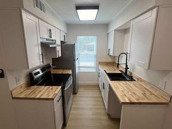 Modern kitchen with large widow to pull in lots of natural light for uplifting cooking experience.