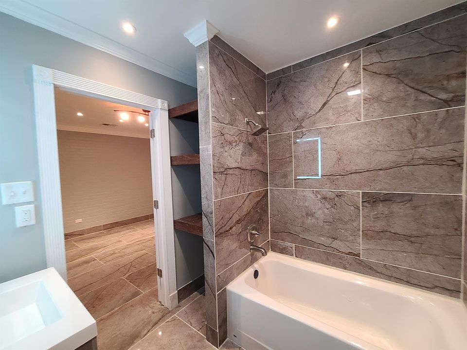 Brand new bathroom with built-in stained, custom shelves.