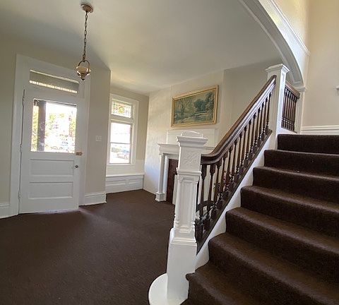 Main entry with original woodwork and fireplace