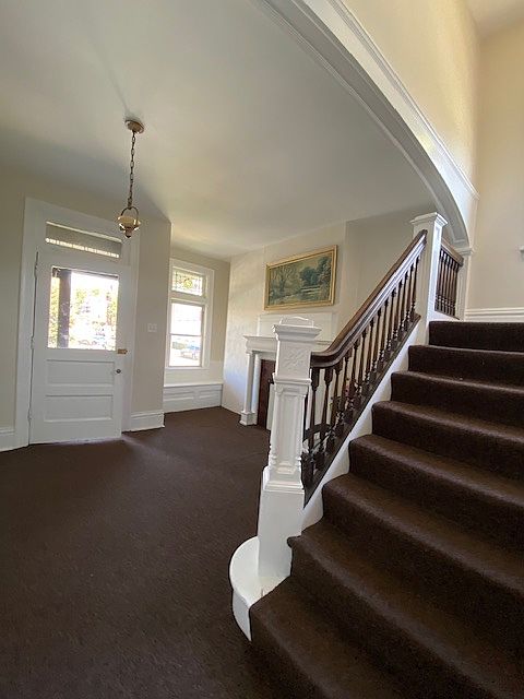 Main entry with original woodwork and fireplace