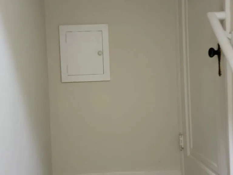 Back entryway to kitchen. With jacket hooks and working vintage laundry chute.