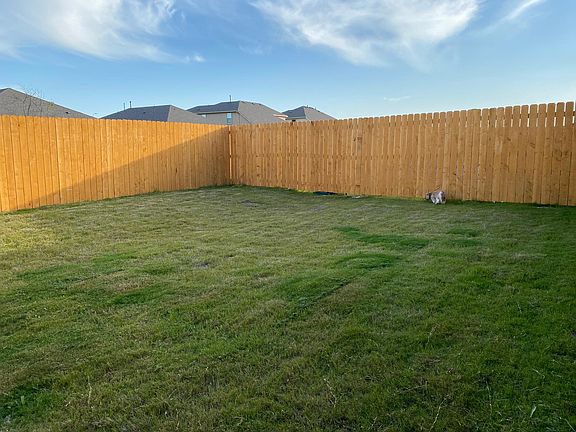 Big back yard with sprinkler system and privacy fence.