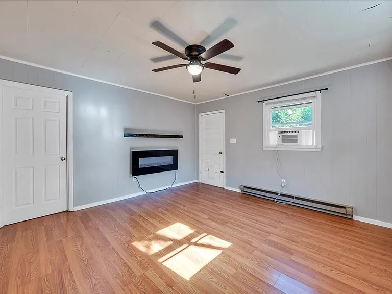 Den w/ Designer Ceiling Fan and Door Leading to Private Fenced In Backyard! Blinds Provided by Landlord! NEW Black Matte Curtain Rods Installed by Landlord!