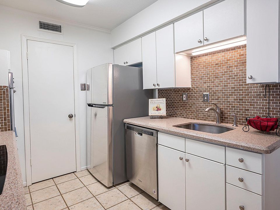 Beautiful kitchen with granite counters, stainless sink, dishwasher and refrigerator.