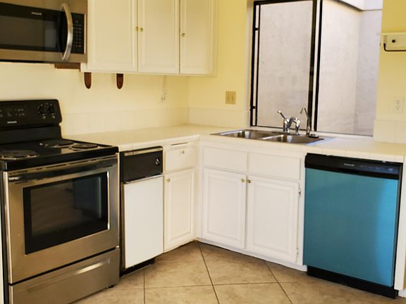 Bright eat-in kitchen with lots of storage and views of the back and private garden atrium.