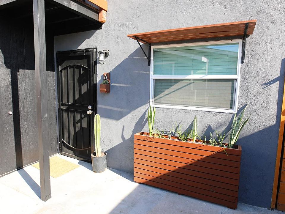 Downstairs duplex apt unit A with modern overhang and plante
