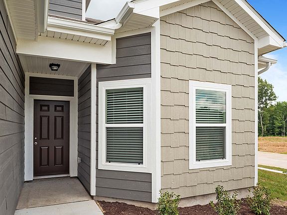 The Cypress has a charming, covered front entryway and gorgeous bay windows