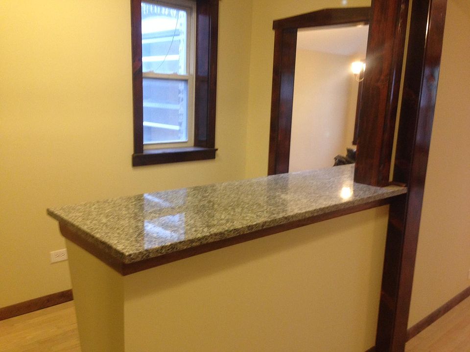 Hallway view from kitchen pantry. Granite counter top