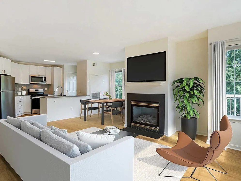 Renovated Package IV kitchen, living, and dining areas with hard surface plank flooring - Avalon Tysons Corner