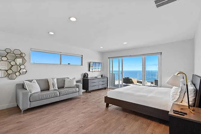 Our second bedroom offers a comfortable sofa for indoor lounging and a charming outdoor sitting area.