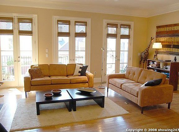 Huge great room has a gas fireplace and three sets of French doors that open to the oversized deck a