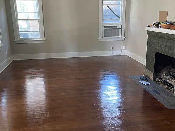 Living room, with working gas fireplace, natural lighting, high ceilings, hardwood floors