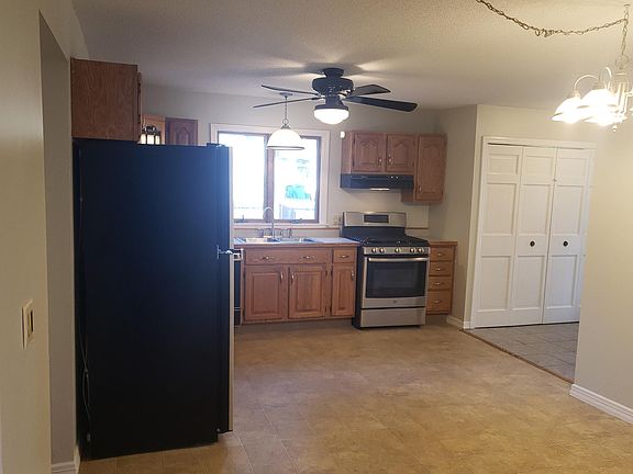 View of kitchen and pantry from entrance to two bedrooms.