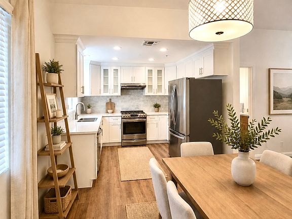 Updated kitchen including refrigerator, oven, and dishwasher. Furnished photos are virtually staged for reference. No furnishings are included with lease.