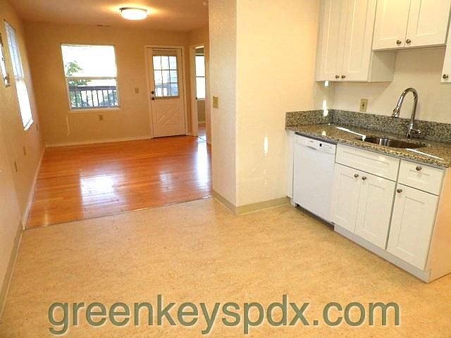 Kitchen and living room looking towards balcony door