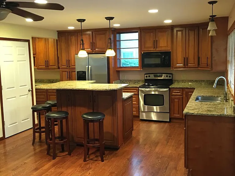 Gourmet kitchen with large island, plenty of storage and stools.